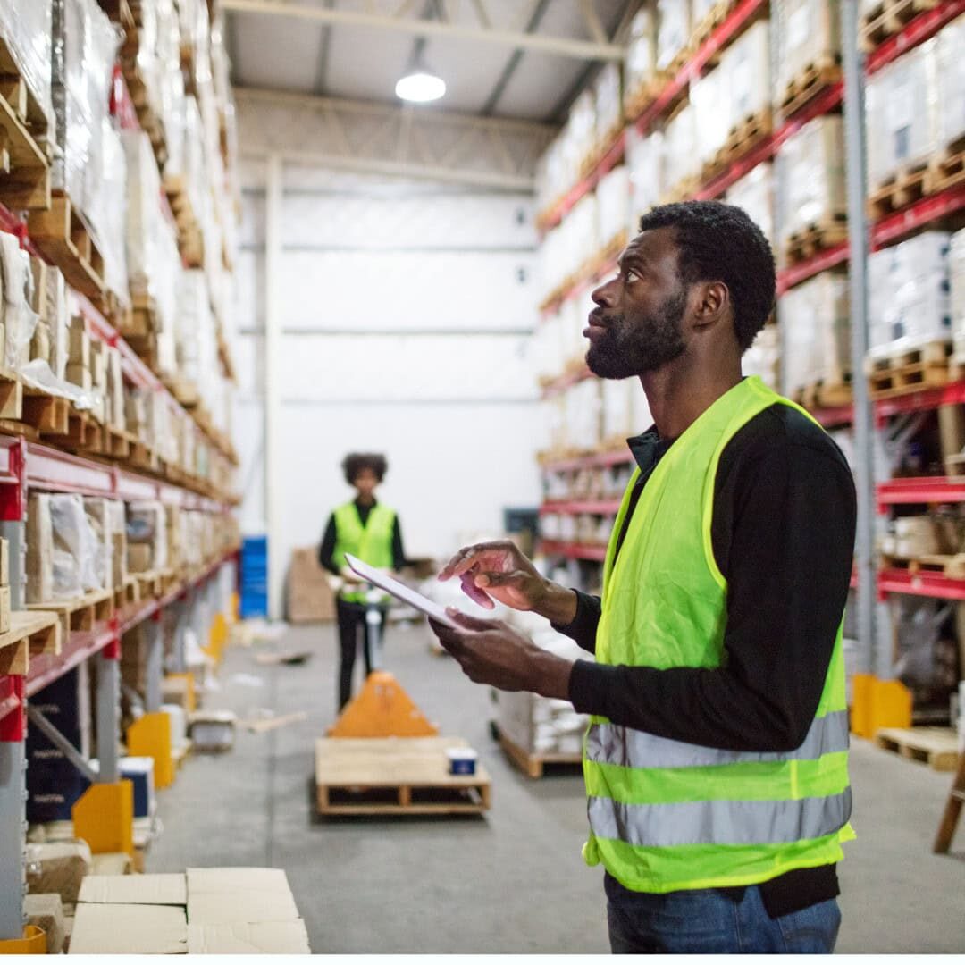 inventory management master Warehouse workers in vests organizing shelves