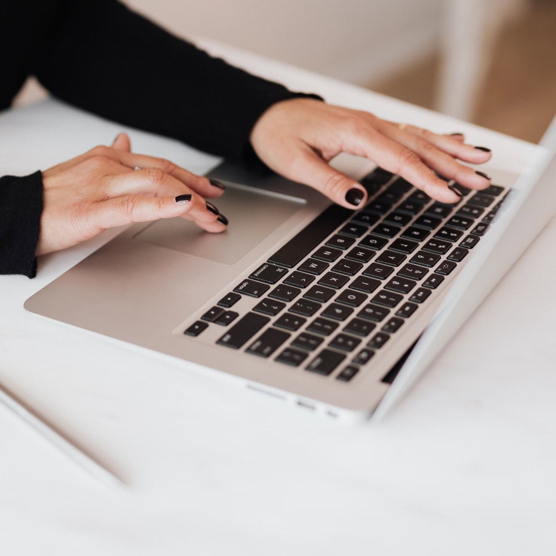 browse products Person typing on a laptop keyboard